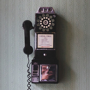 An old style coin operated dial phone to represent the telecommunications industry.